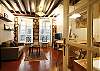 Kitchen is on the right, you have a view of the pedestrian street from the 2 windows.