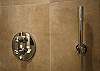 In the bathroom, you have an extra large mirror and lights and an extra large modern shower with a glass door.