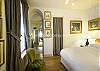 Opulent curtains and bright natural light fill the master bedroom with splendor