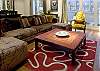There is a refined mosaic table in front of the sofa.