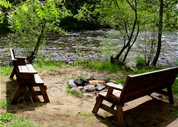 Firepit by the Salmon River at Huckleberry Wilderness Lodge