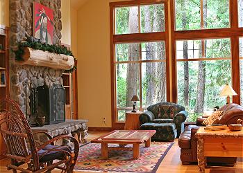 Vaulted great room includes kitchen, dining area and wood-burning fireplace at River Rock Lodge.