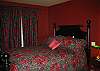 downstairs bedroom w/ queen bed and fireplace