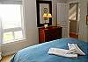 The upstairs bedroom has water and hillside views....