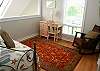 The loft is another cozy sitting area with a comfy rocker and trundle bed.