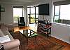 off of the downstairs living room is a sunroom that leads to a deck.