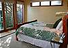 The master suite has doors opening onto the deck and a large private bath with large soaking tub.