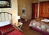 the 3rd dowstarirs bedroom with 1 queen and 1 single. Across from jack and jill bath.