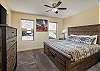 Spacious master suite with beautiful rustic furnishings, a comfortable king size bed, attached bath and views of the Moab Rim.  