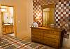 This hanging quilt creates a lovely focal point in this King Master Bedroom.