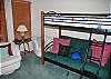 A second bedroom downstairs contains a set of bunk beds.  This one is a special set-up with a futon bed on the bottom and a twin size bed on top.  This is a great room for kids. It is complete with a TV.