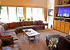 This is a very large couch located in the living room, that will provide plenty of room for all your family and friends. This space also provides great views.