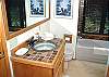 Upstairs bathroom with bath and shower.