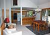 Fully equiped kitchen that looks out to the dining room. Has a bar with four sit down stools and two big chairs.