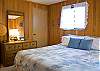 King bedroom with wood accents.