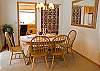 Formal dining room opens on to living room. This dining table has a couple of extra leafs so you can gather everyone around the table for a special meal.