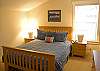 This restful Queen bedroom is located next to the double bunk bed room upstairs.