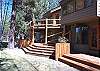 The cascading rear decks include  lounge chairs and side tables for relaxing on the lawn or riverside.