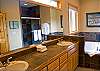 King Master Bathroom with double sinks, jacuzzi tub and shower.