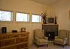 Gas fireplace tucked in corner. Chairs ready for you and a book.