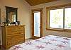 Upstairs bedroom features a king size bed and master bathroom along with access to the upstairs deck.