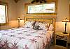 Upstairs bedroom features a king size bed and master bathroom.