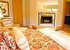 2nd View of Downstairs King Bedroom has woodburning fireplace with connecting bath.