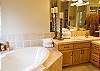 Sunken Bath in upstairs master.  Double side firpelace with walk in shower.