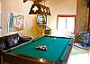 A pool table and nostalgic arcade games occupy the upstairs rec room.
