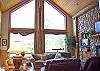 Wide windows let the warm morning sun into this plush living area.  A great place to enjoy a quiet morning with a cup of coffee.  Or gather the family in the evening for a toasty fire and a movie.