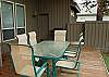 A large deck with table and chairs for 6,  gas BBQ and hot tub.