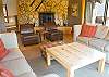 The double sided woodburning fireplace is visible from this comfortable sitting area in the living room or from the master king  suite.