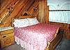 The downstairs bedroom features a King Size Bed. The bathroom is right next door in the hallway.