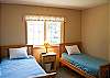 This cute twin bedroom has a  flat screen TV.