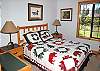 Brightly decorated queen bedroom.