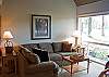 Living Room.  Enjoy the snowfall with the stunning open views from this comfortable condo.