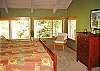 This bright and sunny upstairs bedroom features a king size bed, side chairs, walk-in closet, attached bathroom with jacuzzi, as well as a fantastic river view.