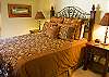This master suite has a queen bed, large master bath with dual sink vanity and walk in closet.