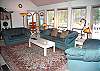 Spacious living room with lots of windows. Light and bright. Enjoy a relaxing weekend in front on the TV. All you need in a blanket and a pillow