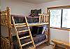 This room is perfect for the kids with a  rustic set of pine bunk beds.  It shares one side of the hall double-bath.