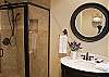 Hall Bathroom.  Beautifully tiled shower with marble pedestal sink.