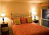 Downstairs master with queen bed has updated linens and a warm feel.