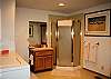 At the end of the hall downstairs is a large bathroom with shower, washer and dryer.