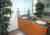 King Master Bathroom.  Two sink vanity with tub/shower and a large walk in closet.  Outside door leading to the privately enclosed hot tub.