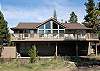 View of back of home with large deck for relaxing or entertaining.