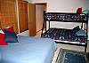 Downstairs bedroom with full size bed and pyramid bunk with full on bottom and twin on top has TV, DVD and VHS.