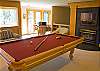 This upstairs game room has a fireplace, pool table with access to the upper deck.