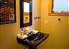 This hall bathroom is conveniently located off of the living room and kitchen and has a shower.