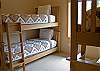This Double Bunk Bedroom sleeps four and shares the hall bathroom with the Queen Bedroom.