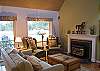 Such a cozy and inviting living room.  Tastefully decorated and so comfortable.
The livong room has wood floors and a gas fireplace.
